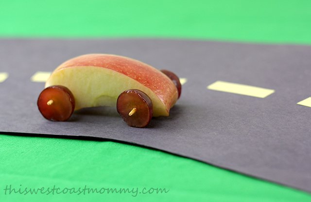 Make this edible Little People wheelie from an apple wedge, grape halves, and a toothpick.