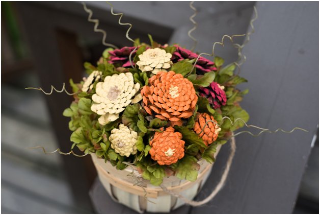  Fall-ify your home with a beautiful arrangement of DIY pinecone mums. Get step-by-step instructions here! 